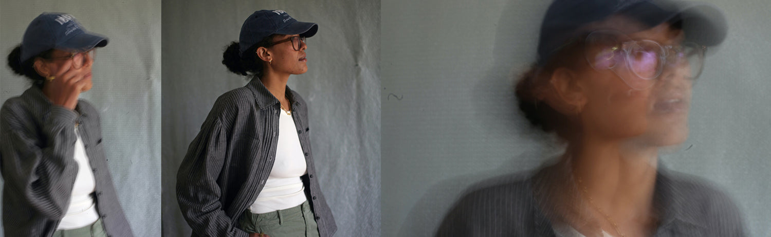 A collage of three photos of a model who is mixed race wearing a dark grey coloured linen shirt. Some of the photos are intentionally blurry so it looks a bit like a painting. 